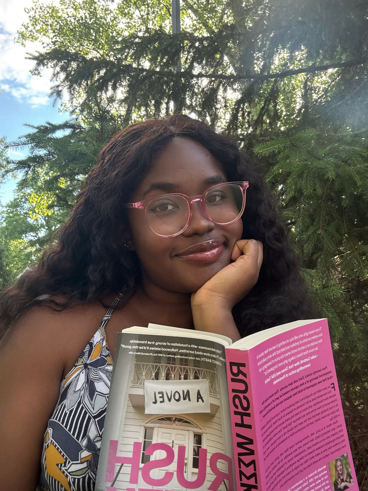 Mary-Esther Anele reading a novel outdoors