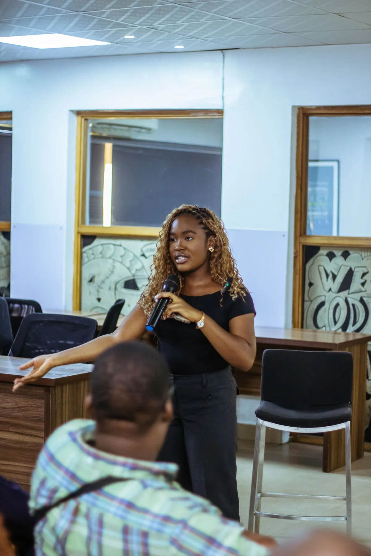 Mary-Esther Anele speaking on stage about product